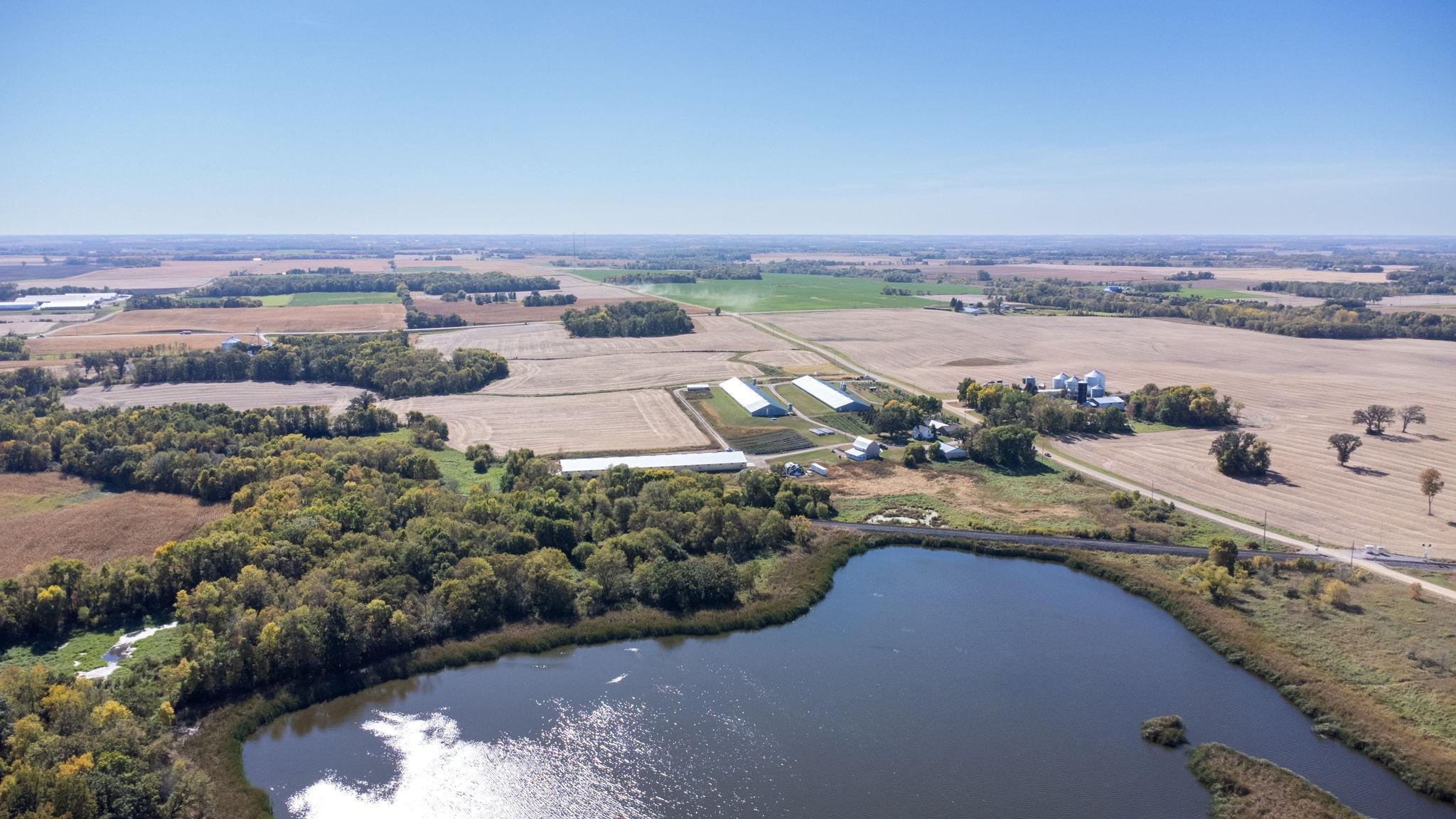 Aerial view looking south. The pond and woods are located on the north side of the property.