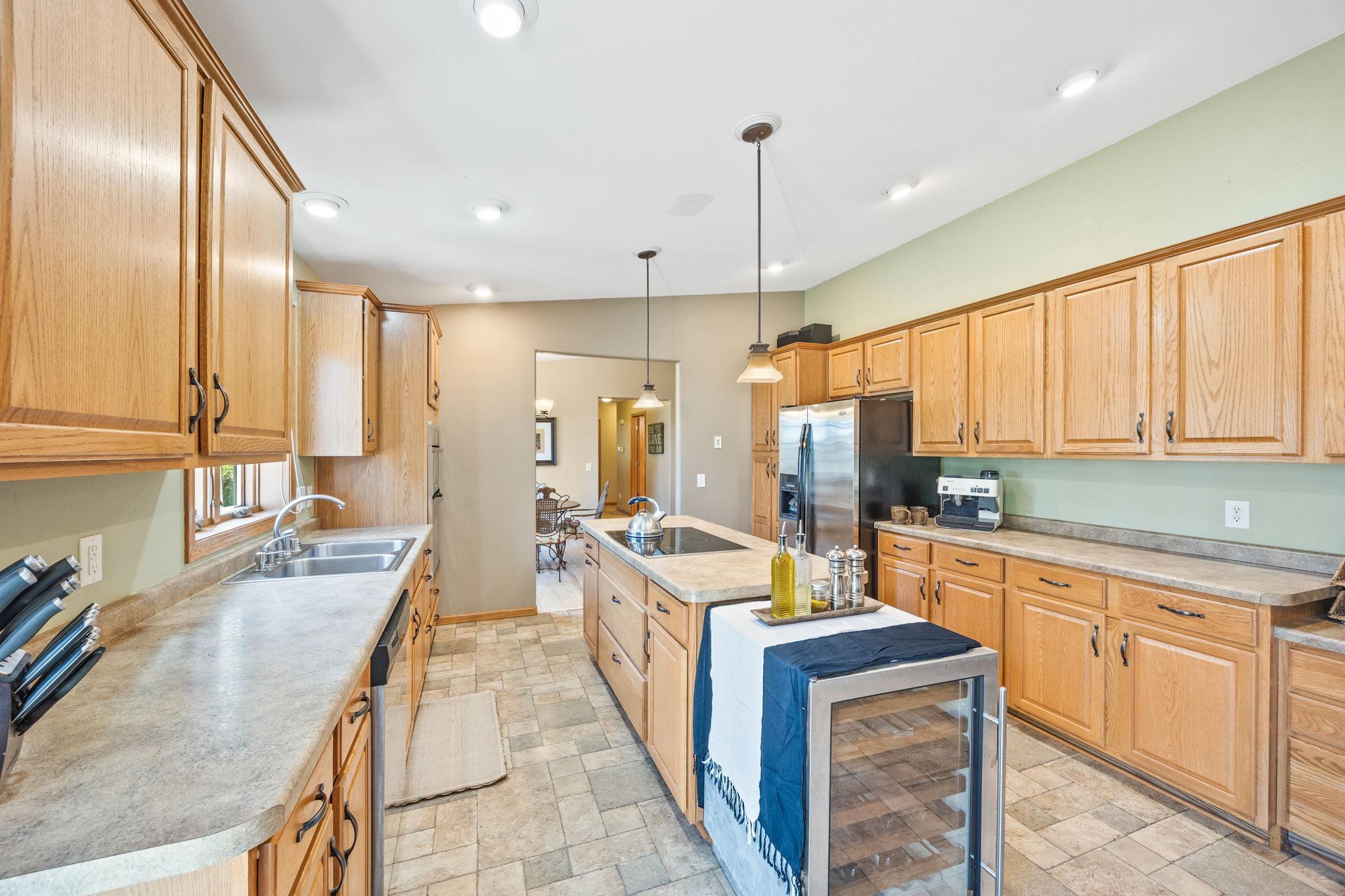 Kitchen with kitchen island and wine cooler.