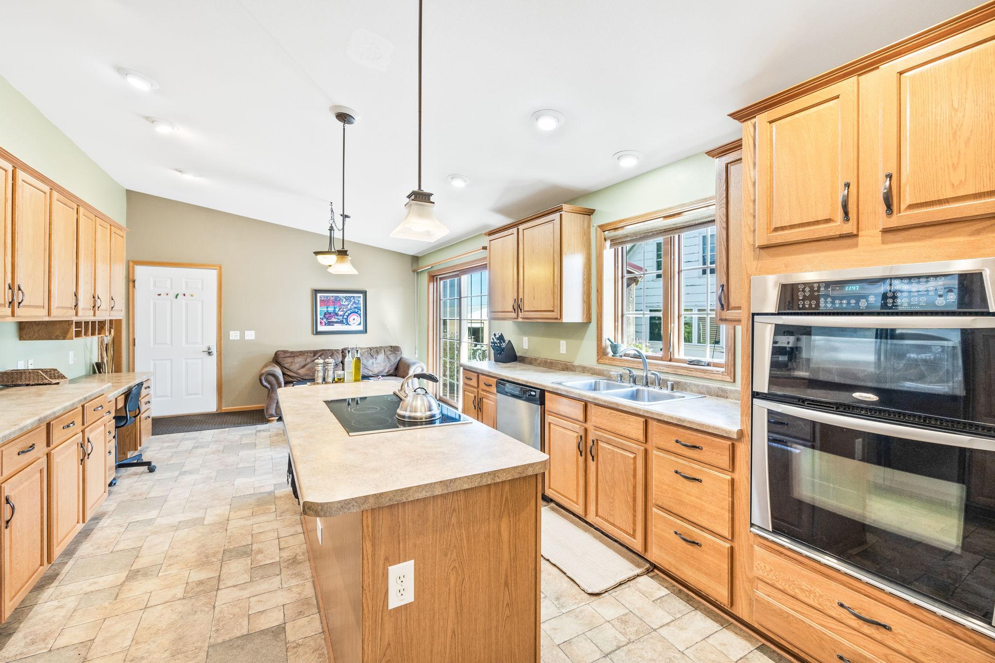 Kitchen and kitchen island. Kitchen window overlooks backyard, deck, and gazebo.