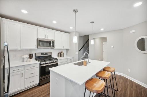 (Photo of decorated model, actual home's finishes vary) Thoughtfully-designed with a combination of functionality and modern design, this kitchen space is sure to impress.