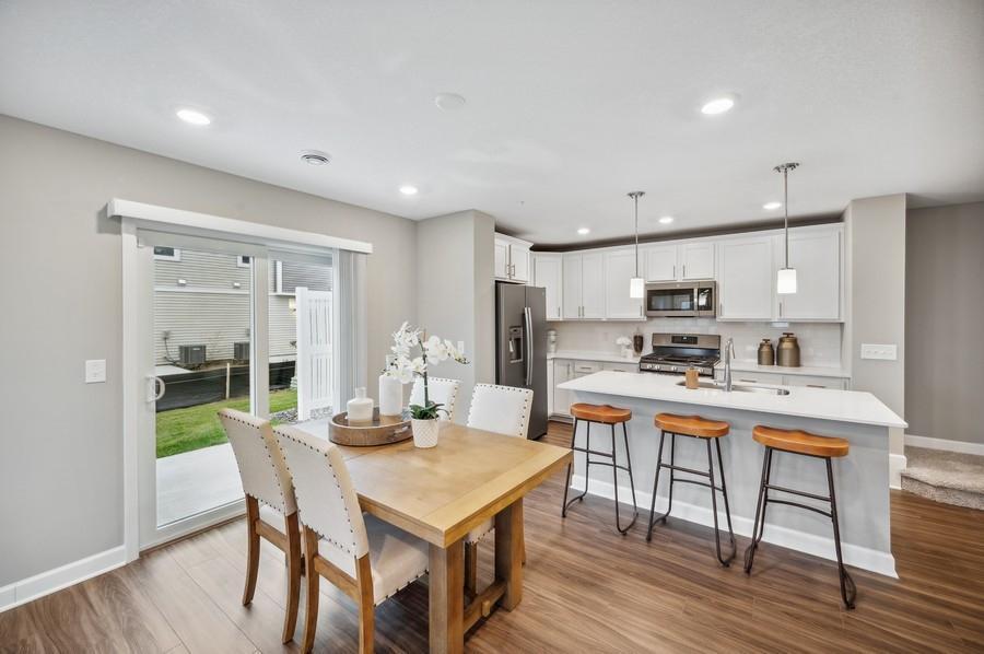(Photo of decorated model, actual home's finishes vary) Soaked in natural sunlight, the homes eat-in dining room has ample space for a dining table located in the heart of the home.