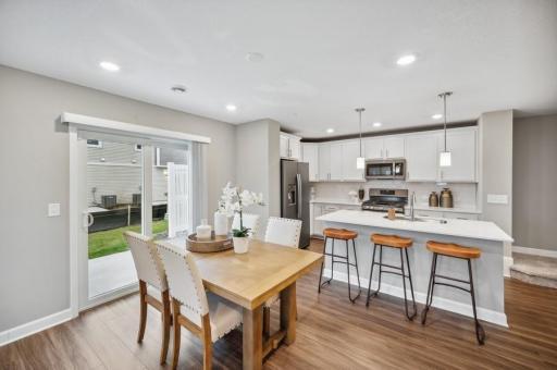 (Photo of decorated model, actual home's finishes vary) Soaked in natural sunlight, the homes eat-in dining room has ample space for a dining table located in the heart of the home.