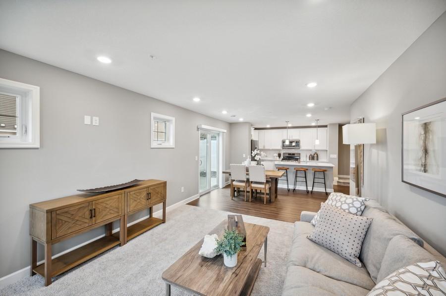 (Photo of decorated model, actual home's finishes vary) The main level seamlessly transitions from room to room while maintaining an open-concept layout throughout.