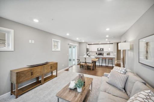 (Photo of decorated model, actual home's finishes vary) The main level seamlessly transitions from room to room while maintaining an open-concept layout throughout.