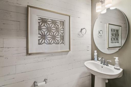 (Photo of decorated model, actual home's finishes vary) Conveniently located powder bath on the main level.