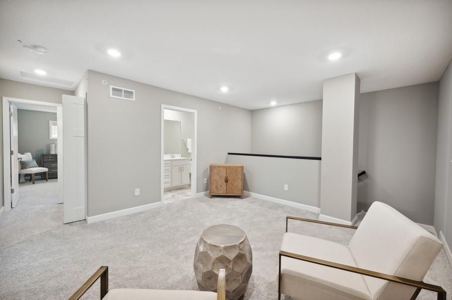 (Photo of decorated model, actual home's finishes vary) Located on the upper level, this perfectly sized living space has enough room for a desk, television and seating for all. Plus, it is just steps away from the three bedrooms.