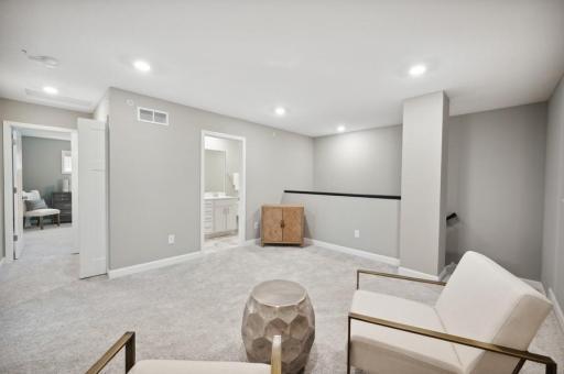 (Photo of decorated model, actual home's finishes vary) Located on the upper level, this perfectly sized living space has enough room for a desk, television and seating for all. Plus, it is just steps away from the three bedrooms.