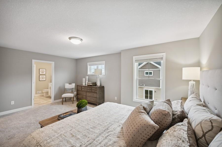 (Photo of decorated model, actual home's finishes vary) Spacious, imaginative and modern would best describe the owner's suite.