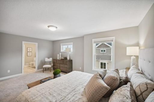 (Photo of decorated model, actual home's finishes vary) Spacious, imaginative and modern would best describe the owner's suite.