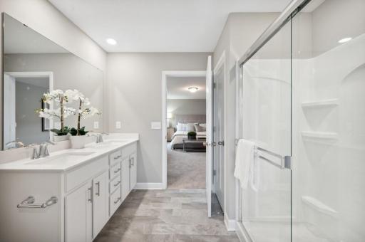 (Photo of decorated model, actual home's finishes vary) An extension of the owner's suite, this private and spacious bath contains a double-vanity, a linen closet and a shower.