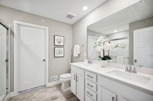 (Photo of decorated model, actual home's finishes vary) Another view of the spacious owner's bath.