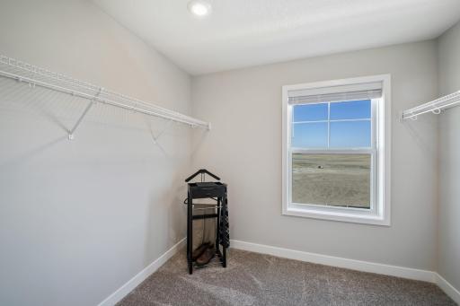 (Photo of decorated model, actual home's finishes vary) The owner's suite features an incredible walk-in closet.