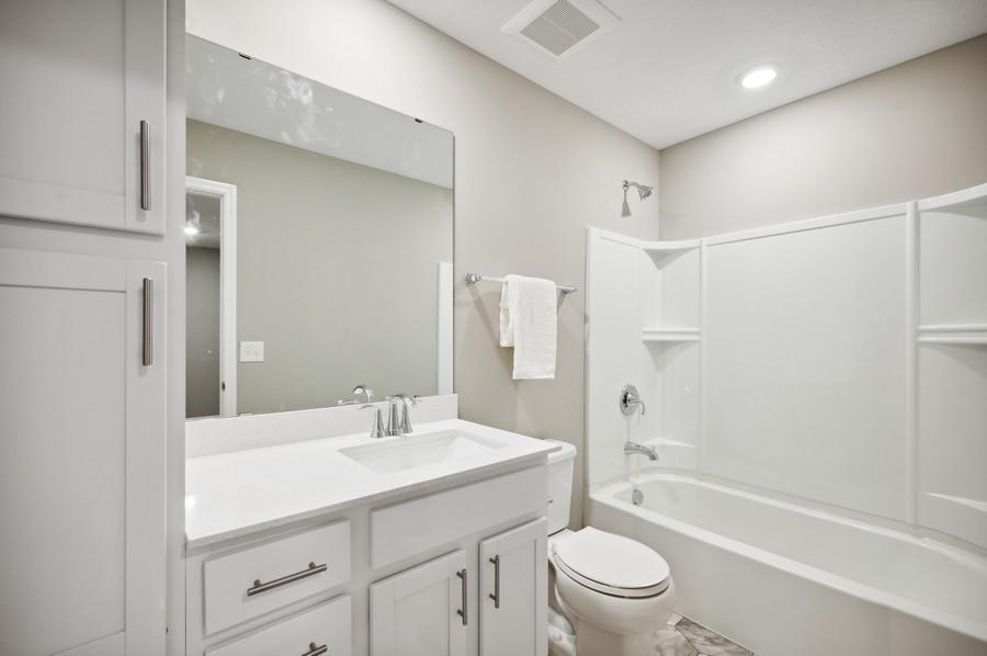 (Photo of decorated model, actual home's finishes vary) The upper level secondary bath is sure to provide plenty of space for everyone to get ready in the morning.