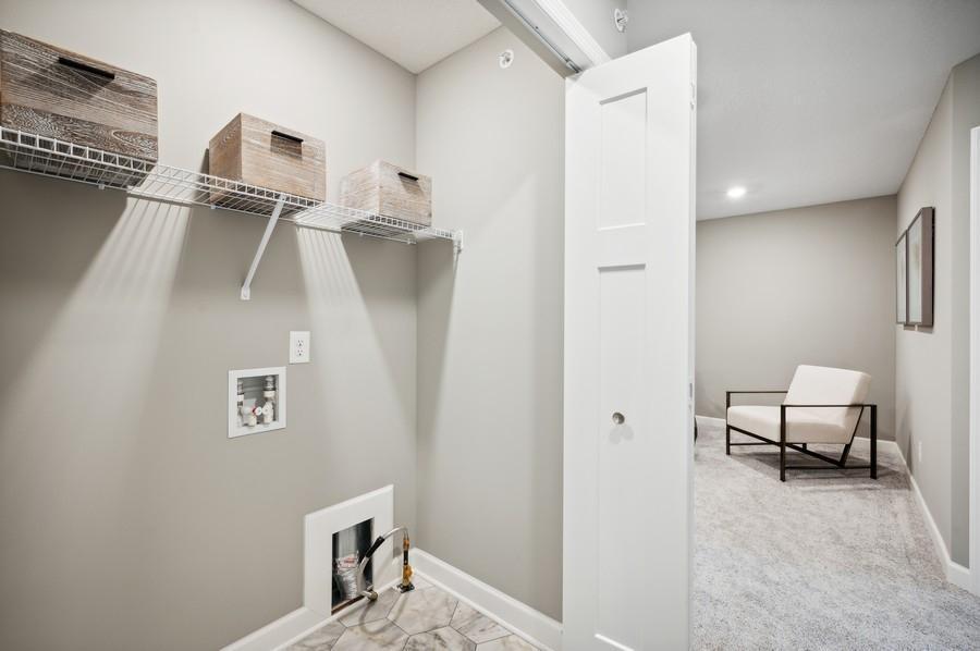 (Photo of decorated model, actual home's finishes vary) Centrally located on the upper level, along with the three bedrooms, this laundry room is sure to provide the ultimate convenience.