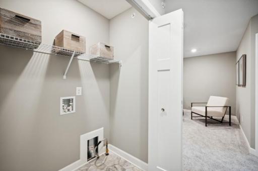 (Photo of decorated model, actual home's finishes vary) Centrally located on the upper level, along with the three bedrooms, this laundry room is sure to provide the ultimate convenience.