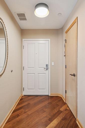 Welcoming entry with new lighting, hardwood floors and a large entry closet.
