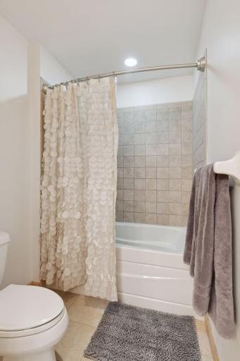 A full bathroom with tile floors and tile tub surround will be yours in the private primary bathroom.