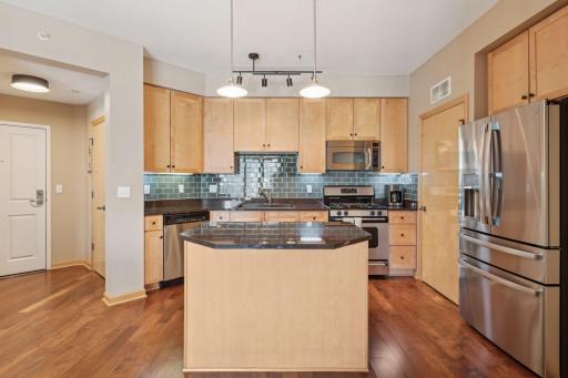 Newer refrigerator with multiple access areas and gas range.