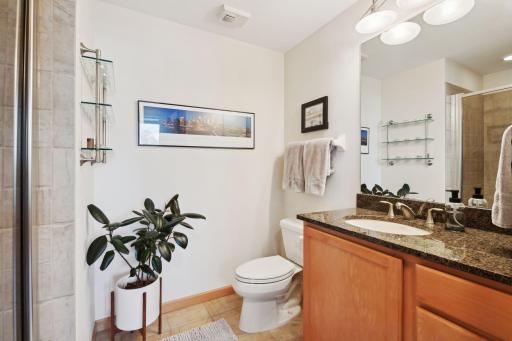 Second bathroom with shower, granite countertops is located across hall from second bedroom.
