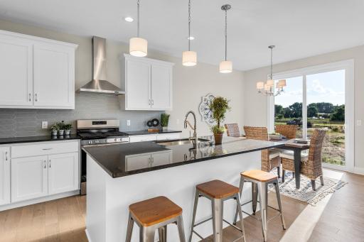 The kitchen is a culinary dream, boasting high-end finishes, a spacious center island, granite
countertops, and stainless steel appliances.
