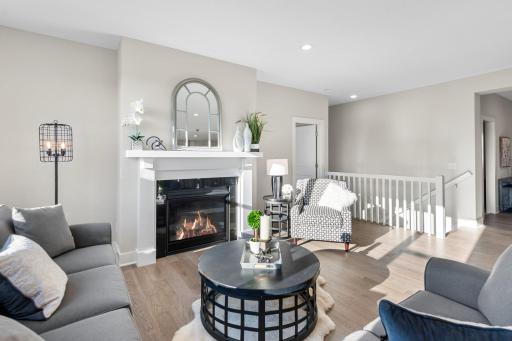 Adjacent to the kitchen, the great room invites relaxation with its cozy gas fireplace, large
windows, and the rich texture of engineered hardwood floors creating a harmonious space
for both intimate gatherings and lively conversations.