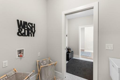For added convenience, access to the laundry room is seamlessly integrated into the owner's suite.