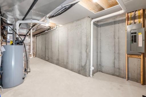 The lower level includes a utility room with abundant storage space. Whether you need space for seasonal items or household supplies, this room is designed to keep everything organized and easily accessible.