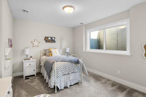 The second lower-level bedroom is bright and welcoming, featuring plush carpeting and a generously sized closet. Ideal for use as a bedroom, home office, or hobby room, this versatile space offers both comfort and flexibility.