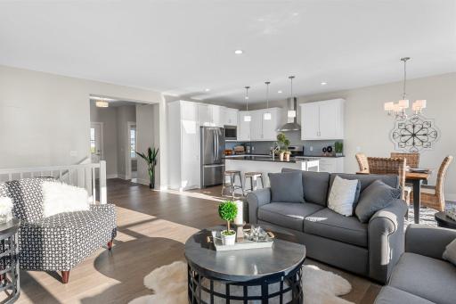 The main floor is where sophistication meets functionality in an open-concept layout
marrying the kitchen, dining, and great room adorned with gleaming oak hardwood floors.