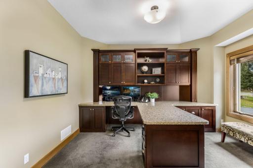 Pair of French doors with decorative glass panels opens to the office