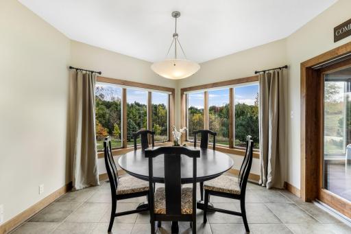 Large windows offers incredible views in the dining area. Full glass patio door with access to the 3 Season Porch