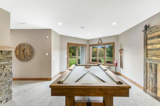 Amusement area is wide open and can accomodate a pool table. Full glass patio door offers access to the property!