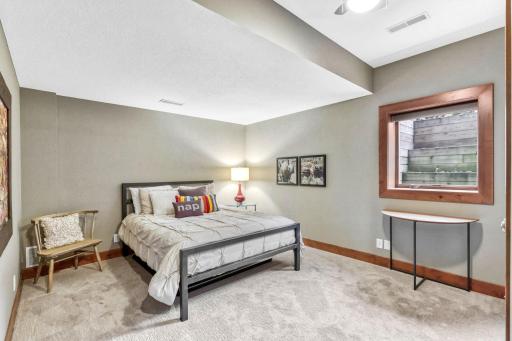 Bedroom 5 in the lower level features large walk-in closet that offers a custom organizer and automatic light