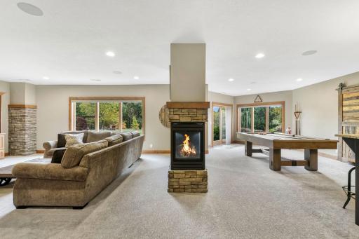 Lower level features a 3-Sided gas fireplace with cultured stone surround