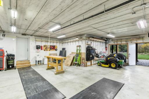 Tuck under garage features gas and Off Peak heater, air exchanger and built-in storage shelving. Double doors (right of picture) with access to the paver patio and property.