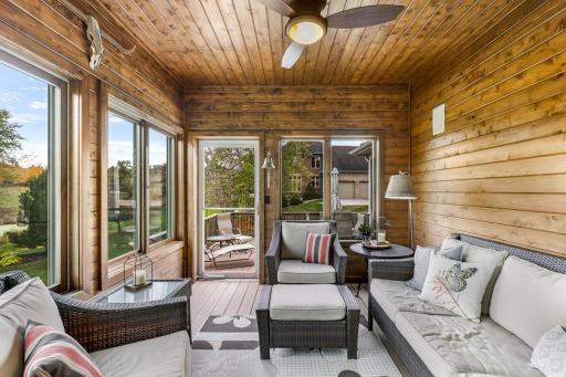 3 Season Porch features ceiling fan and wood paneled walls & ceiling, insulated. Access to the deck which features maintenance free decking