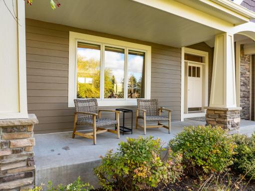 Inviting front porch with cultured stone wrapped pillars