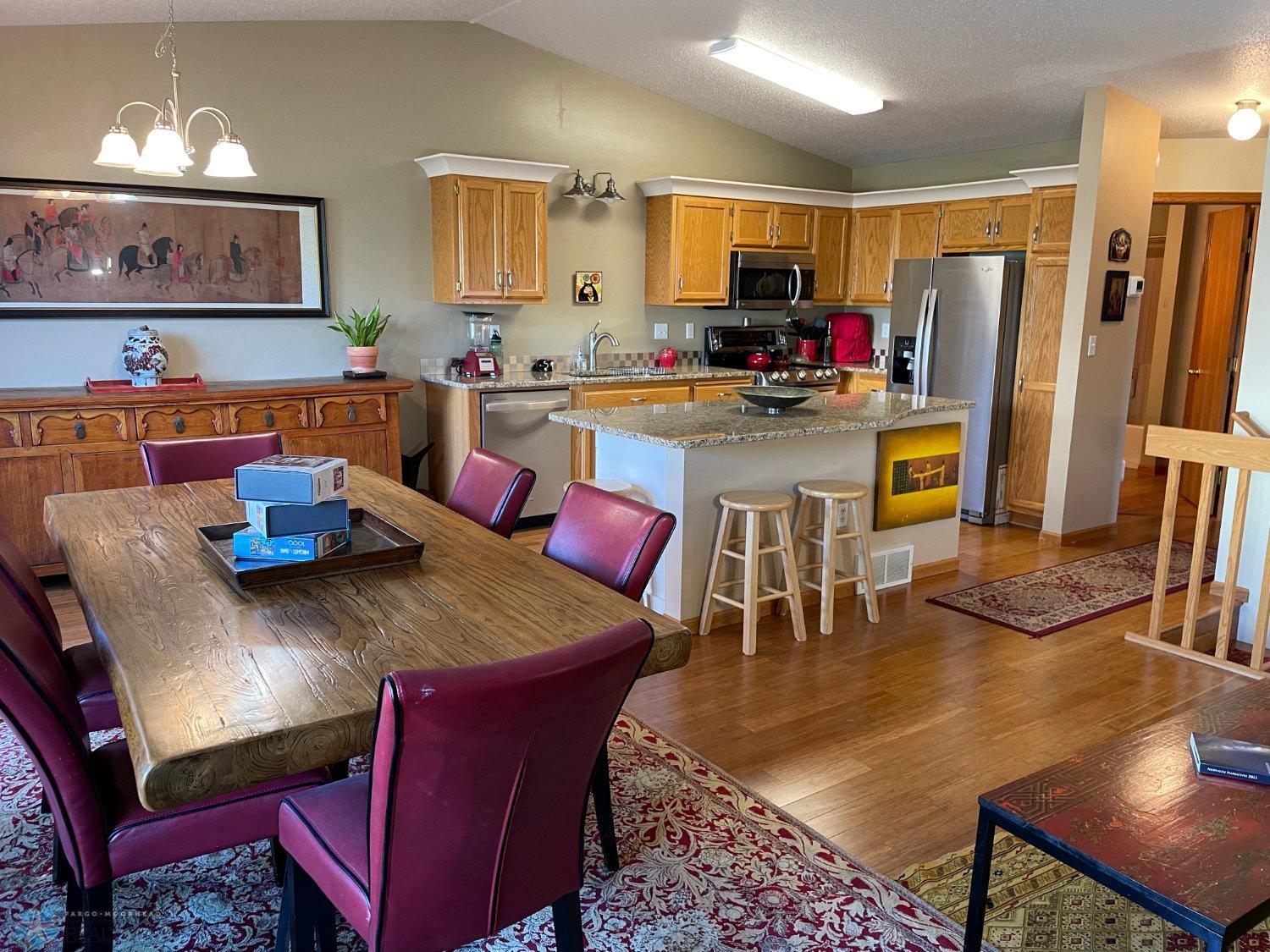 Vaulted living room, kitchen and dining area with solid bamboo hardwood floor.