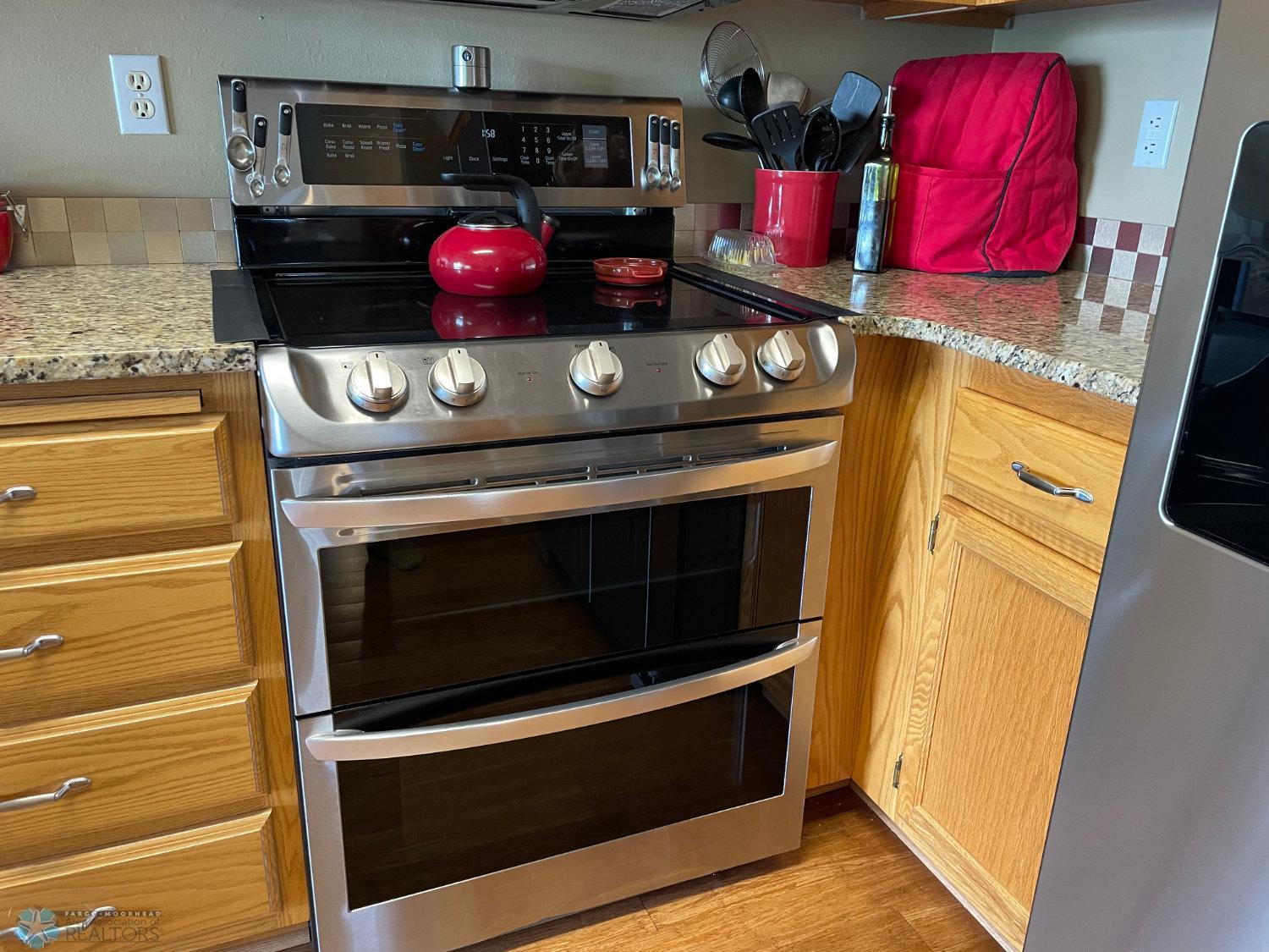 Kitchen stainless steel range with double ovens.