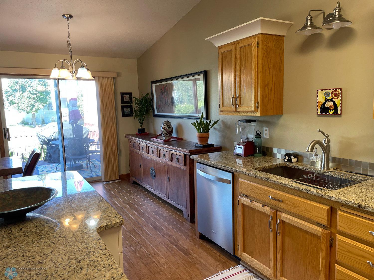 Kitchen view to dining area and patio door. Solid bamboo hardwood floor.
