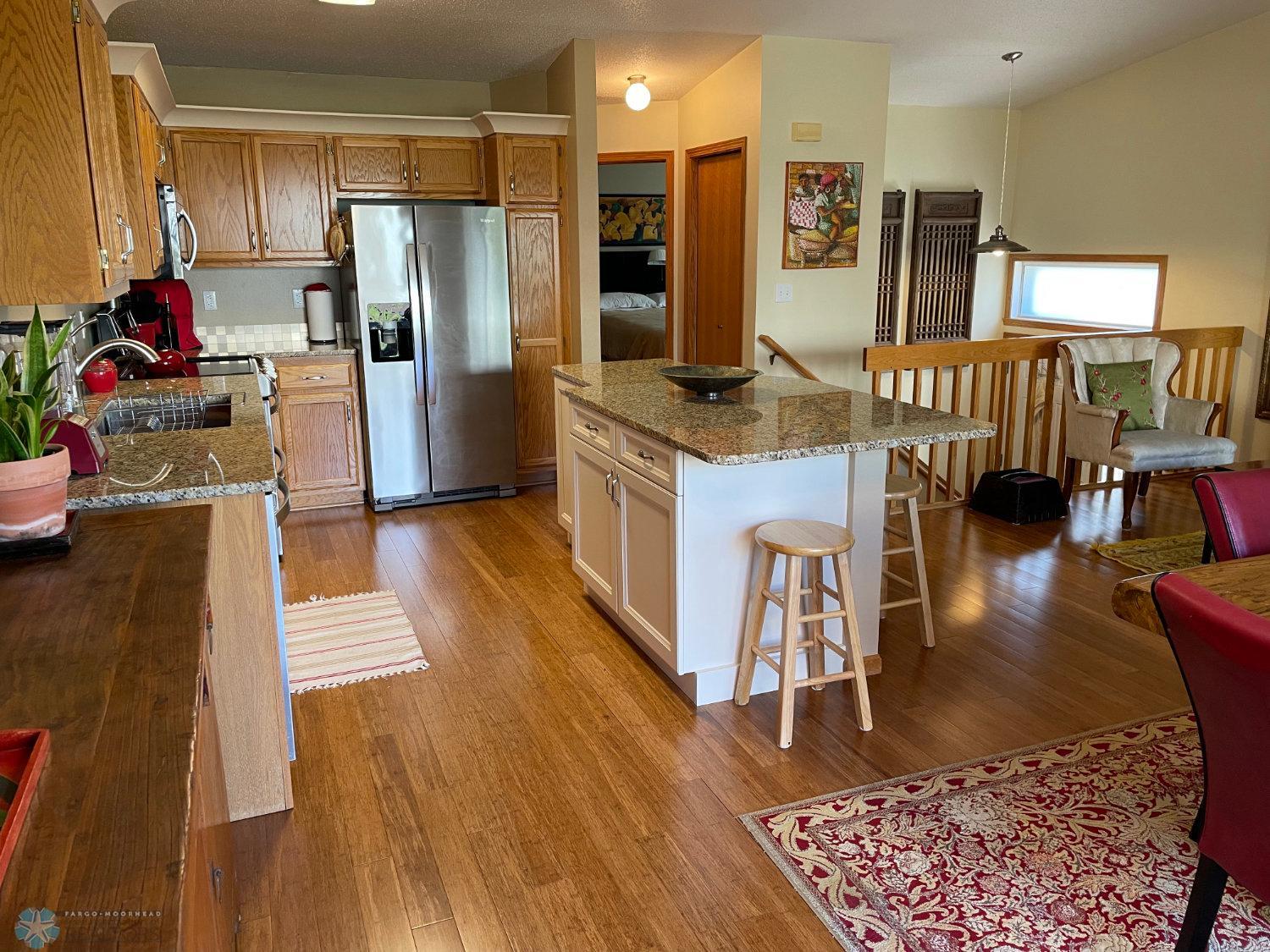 Kitchen viewed from patio door. Solid bamboo hardwood floor.