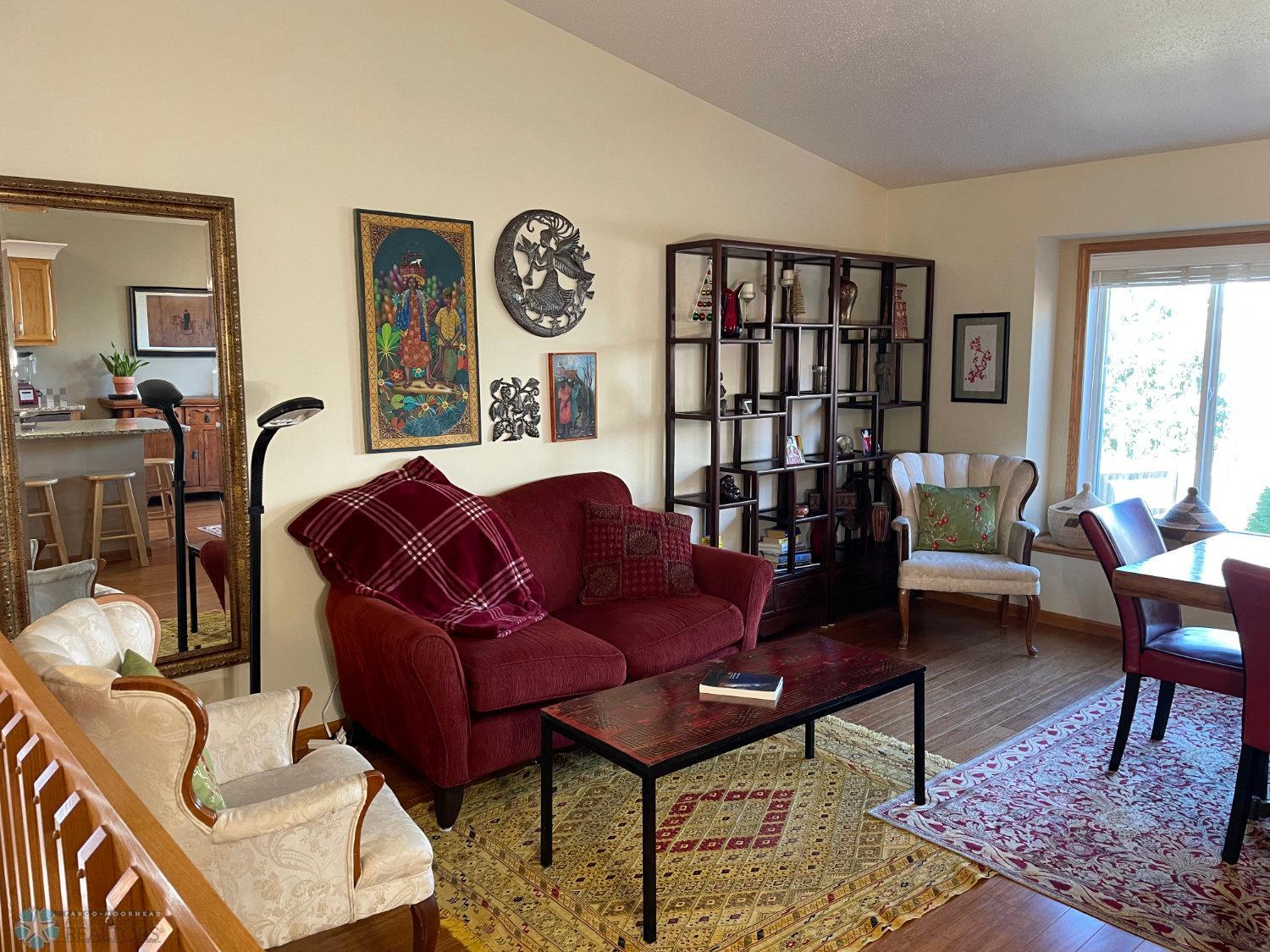 Vaulted living room view from top of stairs. Solid bamboo hardwood floor.