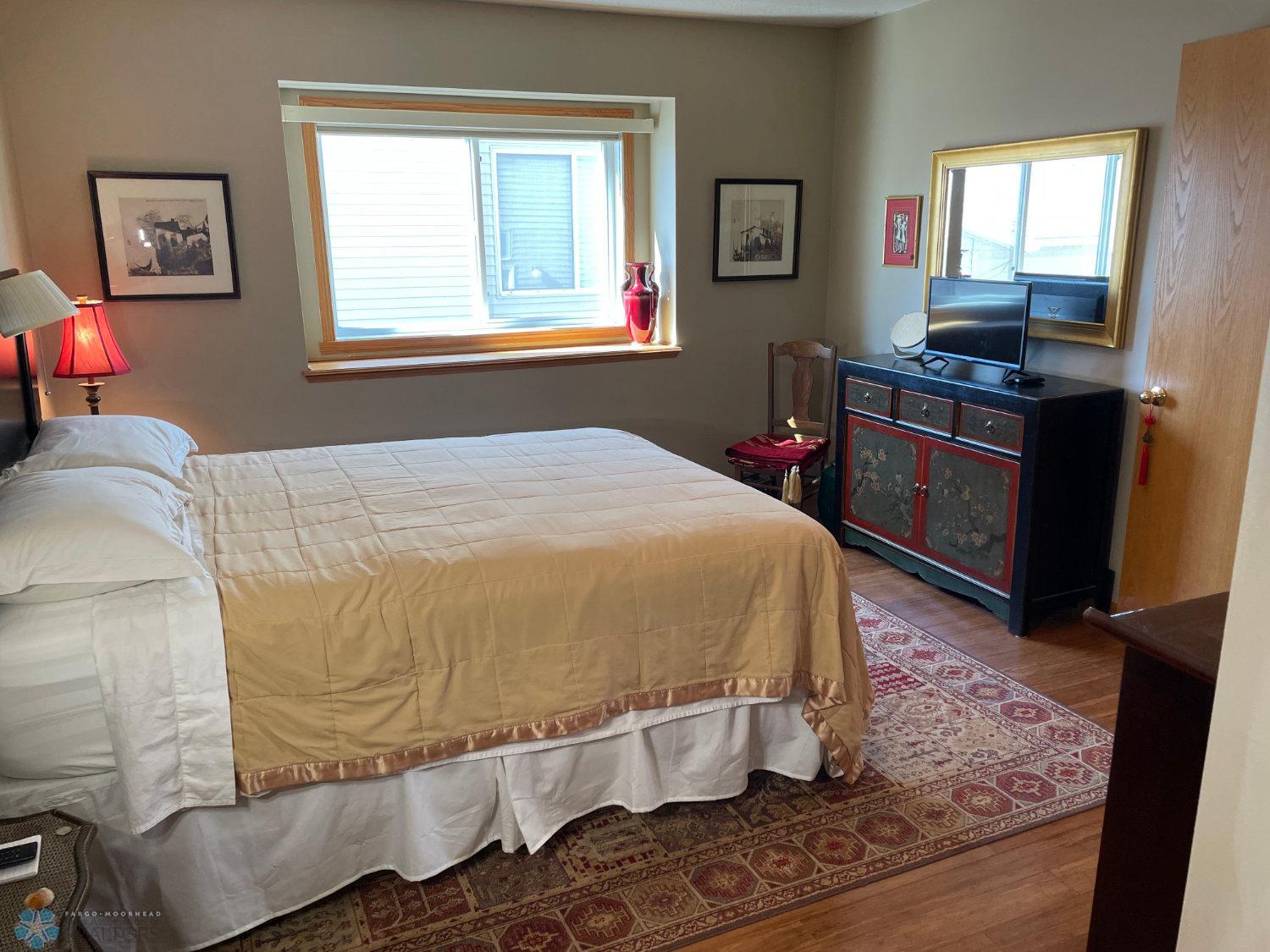Master bedroom view from walk-in closet. Solid bamboo hardwood floor.