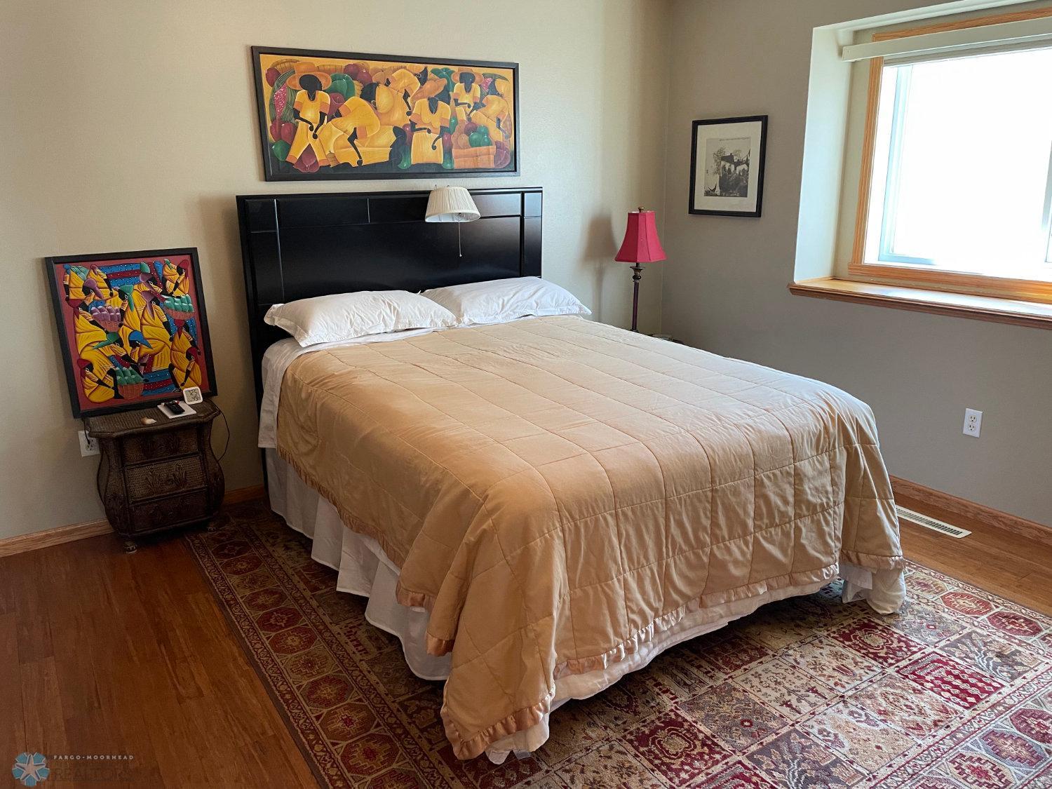 Master bedroom viewed from doorway. Solid bamboo hardwood floor.