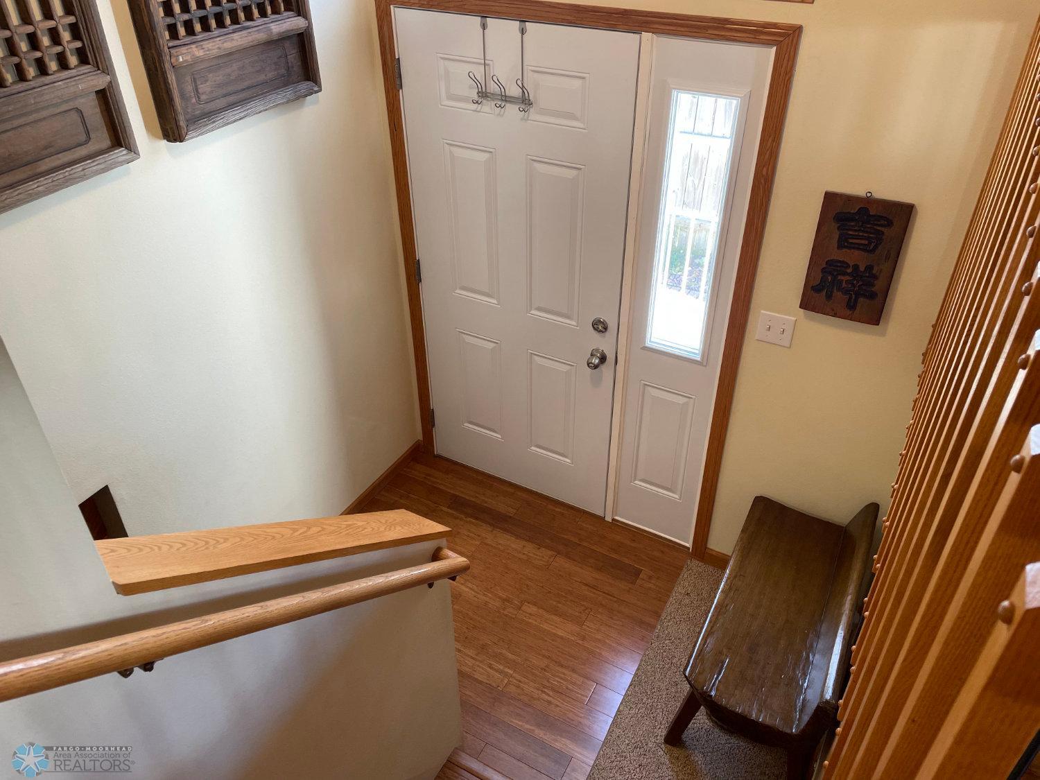Foyer with bamboo hardwood floor and updated front door.