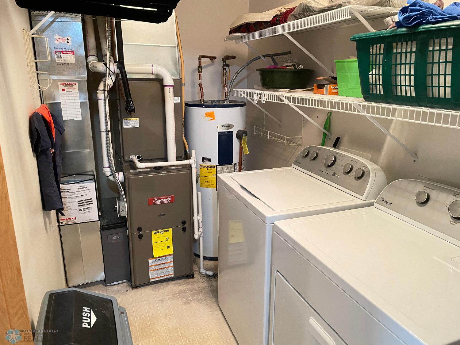 Laundry/furnace room with furnace and A:C new 2024:washer and dryer included.