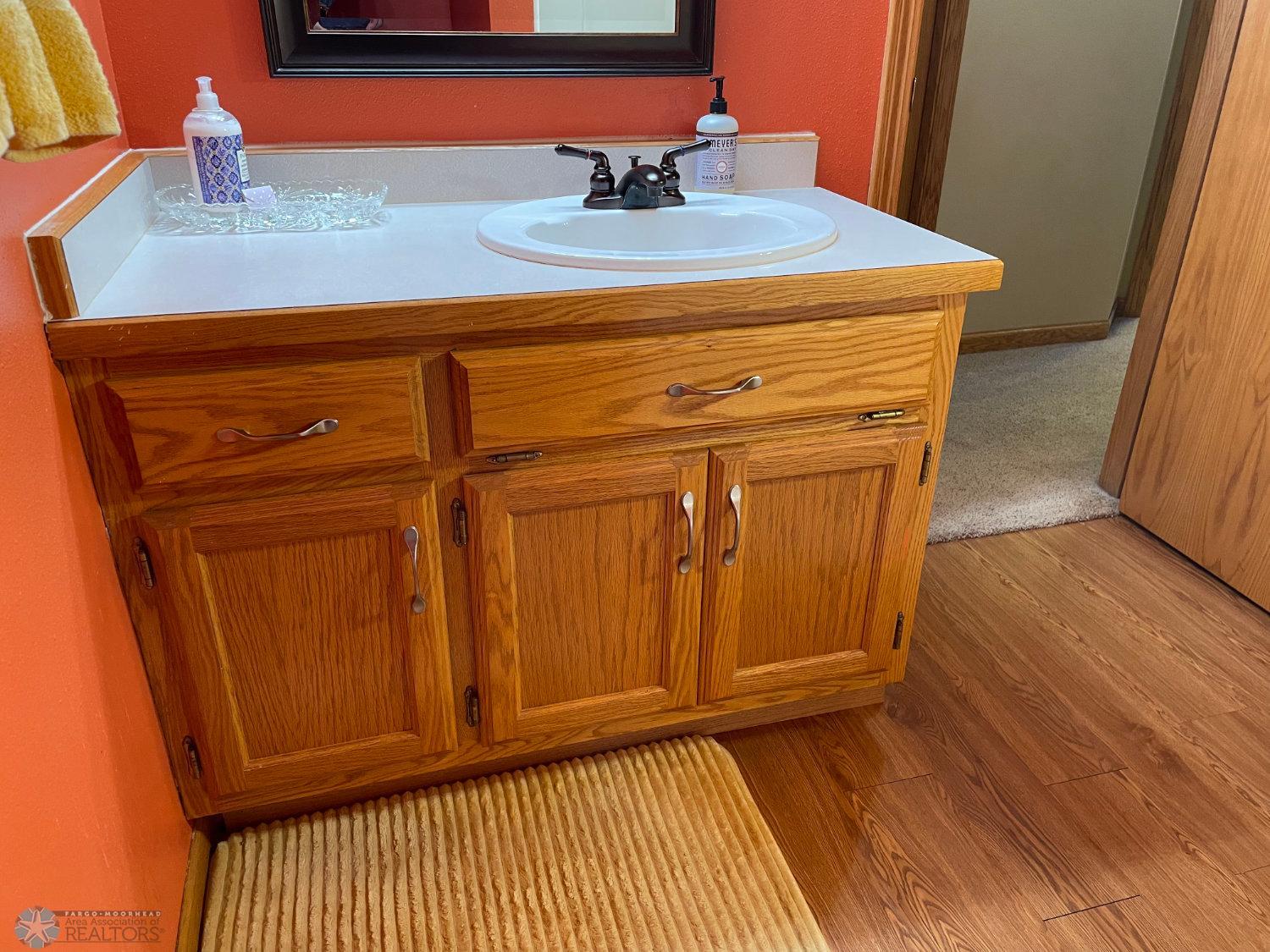 3:4 bath on lower level. View to vanity.