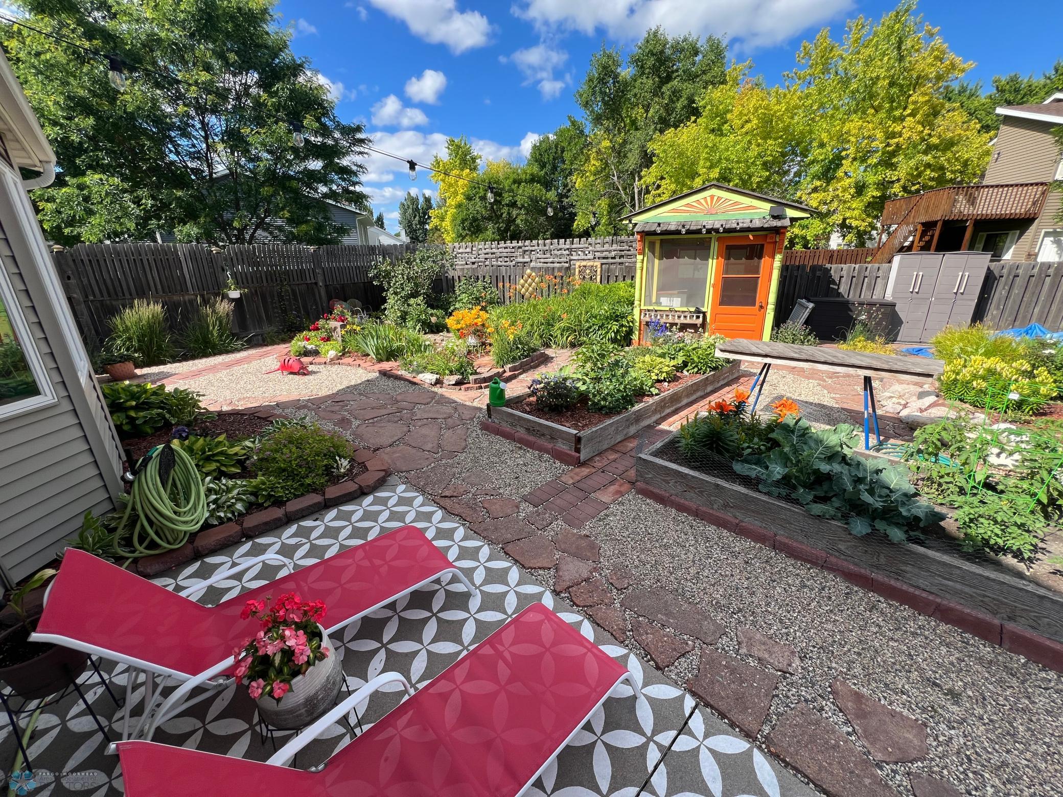 Amazing backyard with flowerbeds, gardens and she shed