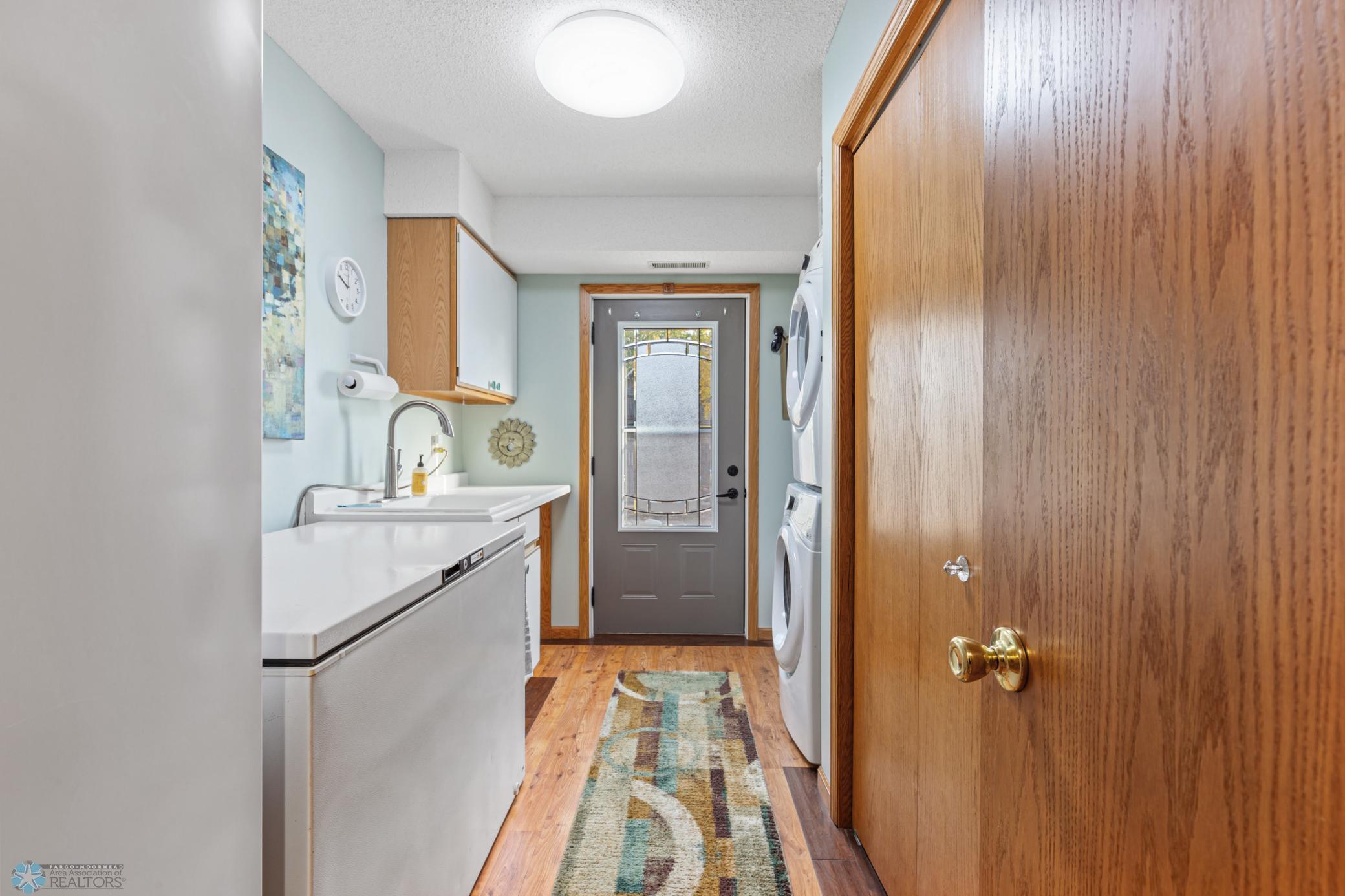 Laundry w/ sink, leads to backyard