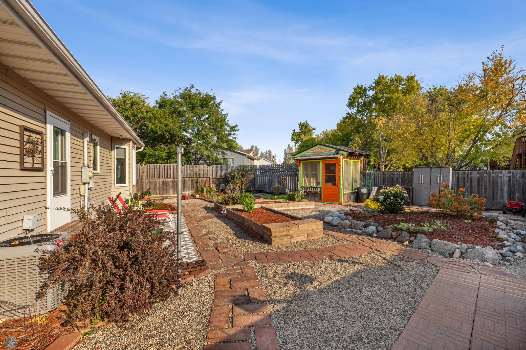 Amazing backyard with flowerbeds, gardens and she shed